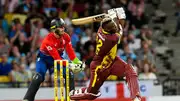 Andre Russell (R) of West Indies hits 6 as Jos Buttler (L) of England watches during the 1st T20I on December 12, 2023. (Getty Images)