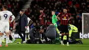 Luton Town manager Rob Edwards enters the field of play as his player Tom Lockyer receives treatment on the pitch.