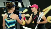 Czech Republic's Linda Noskova (L) embraces Iga Swiatek of Poland after winning in third round of the Australian Open 2024's women's single on January 20. (Getty)