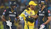 Gujarat Titans' captain Shubman Gill (R) and teammate Sai Sudharsan (L) bump fists as Chennai Super Kings' MS Dhoni walks past during their IPL 2024 match in Ahmedabad on May 10. (Getty)