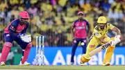 CSK’s captain Ruturaj Gaikwad (R) plays a shot as his RR’s counterpart and wicketkeeper Sanju Samson watches during the IPL 2024 match between CSK and RR. (Getty)