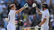 England's Ollie Pope celebrates reaching his century with captain Ben Stokes during Day 1 of the 2nd Test against West Indies at Trent Bridge on July 18. (Getty)