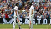 England's Jamie Smith (L) and Chris Woakes touch gloves in their batting partnership during Day 2 of the 3rd Test against West Indies at Edgbaston on July 27. (Getty)