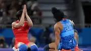 India's star wrestler Vinesh Vinesh (left) celebrates victory against Yusneylis Guzman Lopez of Team Cuba (blue) during the Wrestling Women's Freestyle 50kg Semifinal at Paris Olympics. (Getty)