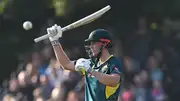 Australia's star all-rounder Cameron Green raises his bat after reaching his half century during the 3rd T20I against Scotland on September 7. (Getty)