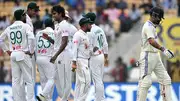 India's Virat Kohli (R) walks back to the pavilion after his dismissal as Bangladesh's players celebrate during the first day of the first Test in Chennai on September 19. (Getty)