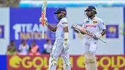 Sri Lanka's Kusal Mendis (L) celebrates after scoring a half-century as his teammate Kamindu Mendis looks on during Day 2 of the second Test against New Zealand at the Galle International Cricket Stadium on September 27. (Getty)